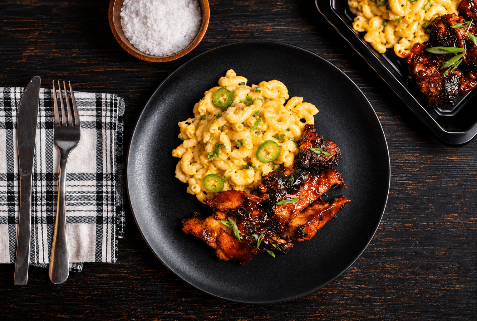 Tender boneless, skinless chicken thighs glazed in our house-made BBQ sauce and served alongside creamy three-cheese pasta. Finished with sliced jalapeños for the perfect balance of smoky, cheesy, and bold flavor.