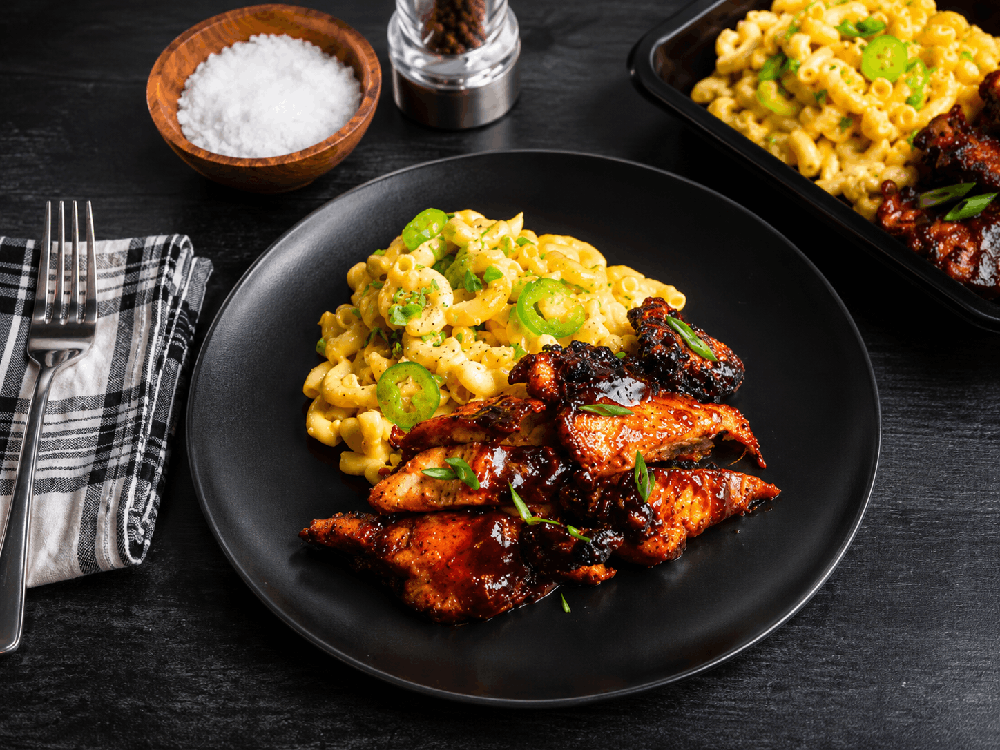 Tender boneless, skinless chicken thighs glazed in our house-made BBQ sauce and served alongside creamy three-cheese pasta. Finished with sliced jalapeños for the perfect balance of smoky, cheesy, and bold flavor.