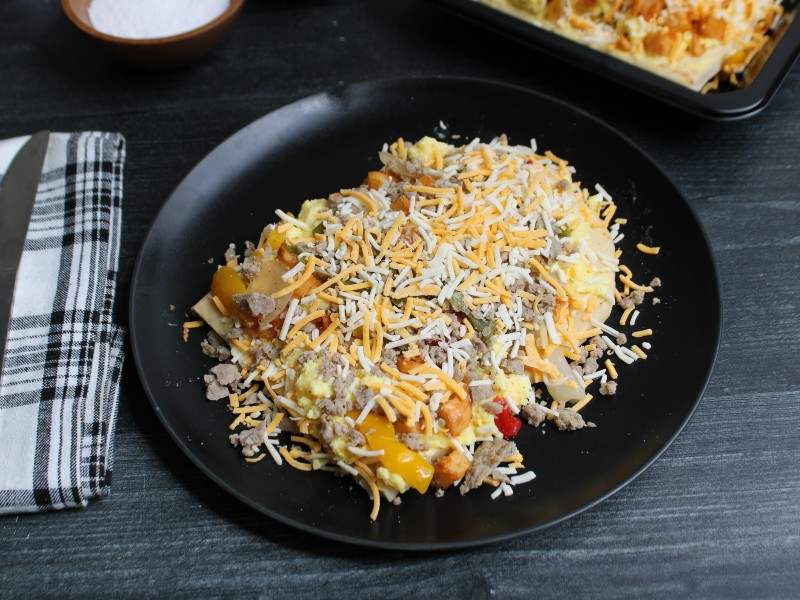 Chicken sausage breakfast flatbread with scrambled eggs, peppers, onions, and melted cheese