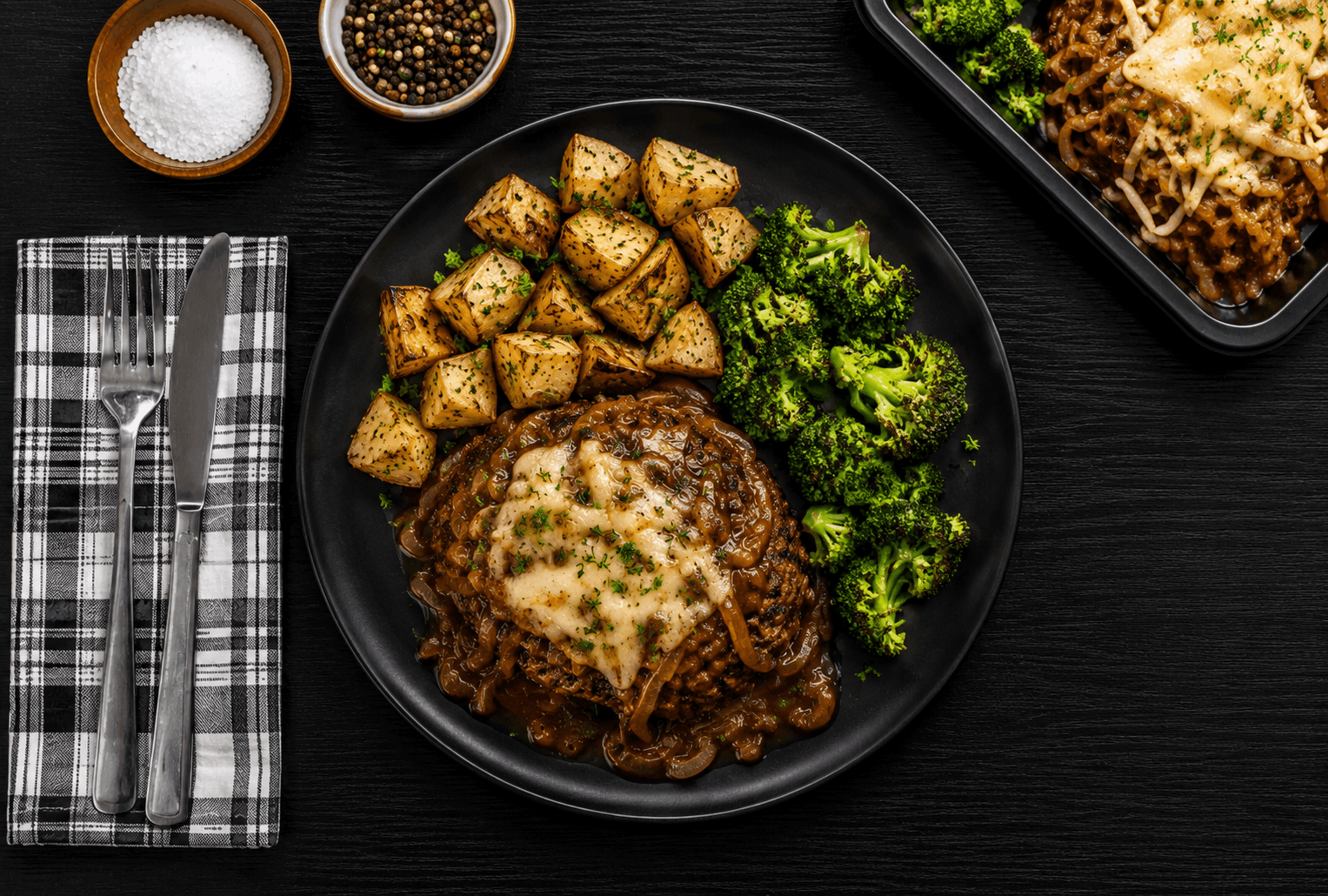 Savory beef meatloaf infused with rich French onion flavors, topped with caramelized onions and melted Gruyère cheese. Served alongside crispy roasted potatoes and tender broccoli for a hearty, comforting plate.